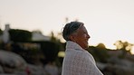 Happiness, sunset and senior woman at a beach with peace and a smile outdoor. Nature, sea and elderly female person with mindfulness feeling calm, happy and relax by the ocean smiling on holiday 