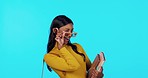 Happy, sunglasses and face of a woman with books for education isolated on a blue background in a studio. Smile, stylish and portrait of a girl wearing cool eyewear for college, school and studying