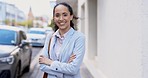 Business woman, face and corporate employee in the city on a road with arms crossed. Happiness, smile and ceo confidence of a female worker with company vision and motivation on a urban street