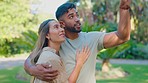 Pointing, date and happy couple holding hands with love and a smile outdoor on summer day. Happiness, nature and embrace of a man and woman together for holiday and romance on vacation in a garden