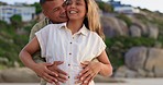 Pregnancy, love and couple on beach, hug and happiness on summer break, bonding and quality time. Pregnant, man and woman touching stomach, excited and cheerful on seaside getaway, smile or affection