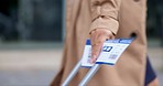 Closeup, hand and woman with a ticket, travel and break with permit for travelling and luggage. Zoom, female employee and worker with a passport, business or documents for trip, suitcase or paperwork