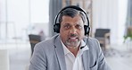 Businessman, face and video call with headphones consulting in virtual meeting or customer service at the office. Portrait of man consultant agent with headset for online advice, help or contact us