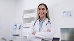 Face, doctor or happy woman with smile or arms crossed in a hospital for wellness, help or nursing. Portrait, medical surgeon or proud Indian healthcare nurse smiling or working in office clinic