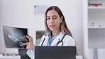 Healthcare, woman and doctor with a scan, video call and meeting in hospital,  explain diagnosis and cure. Female employee, worker and medical professional with a laptop, wellness and conversation