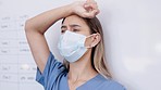 Doctor, sad woman and stress with face mask in fail, anxiety or burnout at the hospital. Upset, anxious or unhappy female medical professional suffering loss, grief or overworked in healthcare clinic