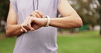 Fitness, watch and man hands check time in a park with rest after workout run and exercise. Outdoor, athlete and smartwatch of a person checking pulse, heart rate and run progress on a training app