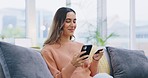 Happy woman, phone and credit card for online shopping, payment or ecommerce on living room sofa at home. Female shopper smiling on mobile smartphone app for purchase, transaction or internet banking