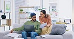 Debt stress, couple and communication at home with mortgage paperwork and computer in a living room. Anxiety, tax problem and banking report issue of a man with financial document and talking wife