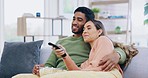 Happy couple, hug and relax watching tv on sofa in living room for fun streaming or entertainment at home. Man and woman relaxing or hugging for movie, popcorn and remote in cozy comfort on couch