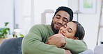 Happy, kiss and couple on a sofa, hug and bonding for quality time, break and relax together at home. Love, man and woman on couch, romantic gesture and commitment for relationship, smile and joyful