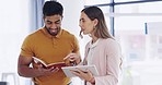 Business man, woman and tablet for discussion with notebook, talking and teamwork for planning strategy. Businessman, partnership and reading notes for goals, ideas or brainstorming at startup office