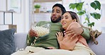 Couple, home and watching tv with horror movie on sofa, scared and shock with popcorn, hug and relax. Man, woman and lounge couch for streaming scary movies, wow and surprise for show on television