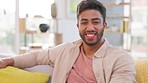 Face, smile and man relax in living room for easy lifestyle, me time and comfortable weekend break at home. Portrait of happy young guy in apartment for rest, good mood and laughing on lounge sofa 