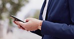 Business woman, phone and hands typing in the city with web networking and communication. Texting, person and internet scroll on social media app with mobile on a network on urban street outdoor