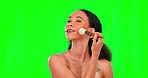 Makeup, brush and happy woman in green screen studio for cosmetic, foundation and blush on mockup background. Smile, powder and skincare by female model with beauty, tool and cheek contour routine