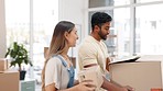 Happy couple, moving and boxes in new home, real estate and property investment for relocation. Man, woman and carrying cardboard box to apartment, house ownership and living room to relax on sofa 