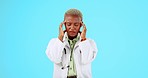 Black woman, doctor and headache in burnout, anxiety or stress against a blue studio background. African female medical professional suffering bad head pain, ache or strain and overworked on mockup