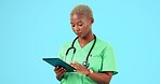Black woman, doctor and tablet in healthcare research, browsing or searching online against a blue studio background. African female medical professional working in medicare with technology on mockup