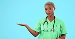 Face, black woman and doctor shake head for no, serious and bad news against a blue studio background. Portrait, female person and medical professional with hand gesture, stop and warning for risk
