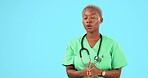 Anxiety, stress and doctor with stethoscope in a studio taking a deep breath for calm mindset. Nervous, scared and young African female healthcare worker with a panic breathing by a blue background.
