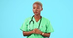 Stress, anxiety and woman nurse in a studio with a panic, unsure or problem expression. Nervous, scared and young stressed African female healthcare worker playing with her hands  by blue background.