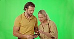 Couple, lost and phone on green screen studio for gps, direction or navigation on mockup background. Smartphone, location and people online for internet, search and app for map while traveling 