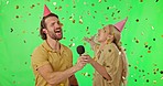 Happy couple, celebration and party confetti on green screen for event, new year or singing against a studio background. Man and woman with mic and glitter enjoying festive time together on mockup
