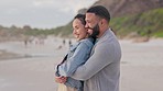 Love, hug and happy couple at a beach for travel, freedom and romance outdoors. Smile, embrace and man with woman on vacation, holiday or trip, bond and cheerful while traveling in Florida together