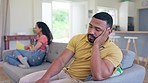 Couple, separation and fight on sofa in argument, conflict or divorce in living room dispute at home. Angry or upset man and woman on couch in depression after disagreement, ignore or fighting