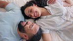 Love, happy couple and relax in a bed from above, smile and sharing romantic morning in their home. Resting, conversation and top view of man with woman in a bedroom waking up, talking and bonding