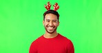 Christmas laugh, man portrait and green screen with holiday party hat with happiness, smile and cheer. Isolated, studio background and Asian male person with happy face to celebrate at festive event