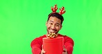 Christmas giving, man portrait and green screen with holiday party gift with happiness and smile. Isolated, studio background and Asian male person with happy face to celebrate with a present