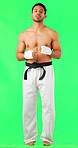 Martial arts, boxing jog and man portrait with green screen and fitness ready for fight. Boxer, karate and mma of a Asian male athlete with exercise, motivation and training for kickboxing in studio