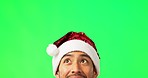 Man, thinking and christmas with green screen in studio with mock up space for holiday promotion. Guy, festive fashion and portrait with excited face, search and looking up for mock up by backdrop