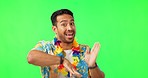Happy, dancing and man in studio with green screen with a colorful hawaiian flower band. Happiness, smile and portrait of male person with crazy, comic and fun dance isolated by chromakey background.