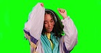 Dance, green screen and woman with headphones, streaming music and happiness against a studio background. Female person, happy lady and model with headset, listening to sounds and dancing with radio