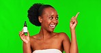 Green screen, beauty and black woman point with essential oil for facial treatment, wellness and skincare. Dermatology, natural face and portrait of female person pointing on chromakey with product