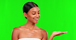 Beauty, product and a woman holding space on a green screen background in studio for natural skincare. Portrait, antiaging or treatment with a happy young female model advertising on chromakey mockup