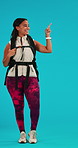 Woman, backpack and happy about hiking in studio with hand for choice, marketing and mockup space. Portrait of african female person with a smile for travel, adventure or fitness on a blue background