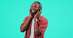 Headphones, music and black man isolated on a blue background listening to audio, mental health and happy. Radio, podcast and model or person streaming sound, technology or electronics in studio