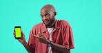 Man, phone and pointing finger at mockup or green screen for bad review on website. Confused black person with smartphone tracking markers in studio for app ux, poor network or internet problem