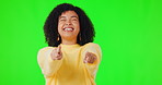 Portrait, point and funny with a woman on a green screen background in studio for a choice or selection.  Hand gesture, motivation or you with a happy young female person indoor to vote on a decision