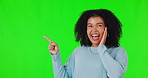 Direction, portrait of woman point and against a green screen. Marketing or advertising promotion, happy for good news or branding and isolated female person with announcement against a chroma key