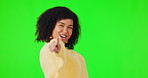 Portrait, pointing and funny with a woman on a green screen background in studio for a choice or selection.  Hands, motivation and you with a happy young female person indoor to vote for a decision