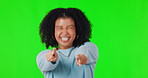 Portrait, pointing and excited with a woman on a green screen background in studio for a choice or selection.  Hands, motivation and you with a funny young female person indoor to vote for a decision