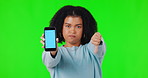 Woman, phone and thumbs down for mockup on green screen with bad review or poor service. Sad African female person with a hand or emoji for website, advertising and app review or ux feedback