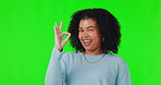 Portrait, woman with hand sign for ok on green screen, studio background and agreement, support and smile for yes. Happy girl, wink emoji and model hands, face and agree, thank you or show opinion