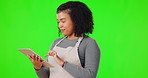 Tablet, typing and woman in a studio with green screen networking on social media or the internet. Technology, browsing and female model chatting on app with a digital mobile by chromakey background.