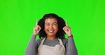 Happy woman, pointing and green screen for advertising, marketing or notification against a studio background. Portrait of female person or waitress looking up and showing advertisement on mockup